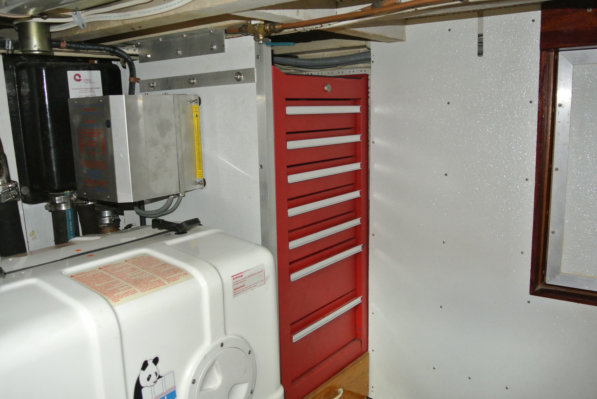 Port forward side of the engine room with tool box storage, and partial view of the new 8kw Generator.