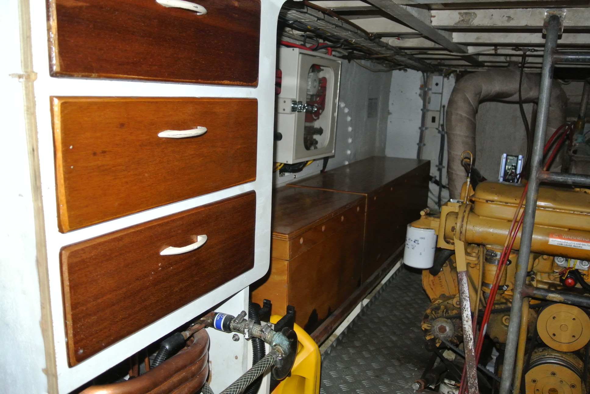 Starboard side of engine room. Drawer storage, Batteries are all in those boxes.